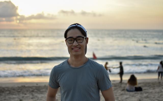 Young man in baseball hat on the beach