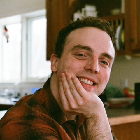 Graduate student smiling in kitchen