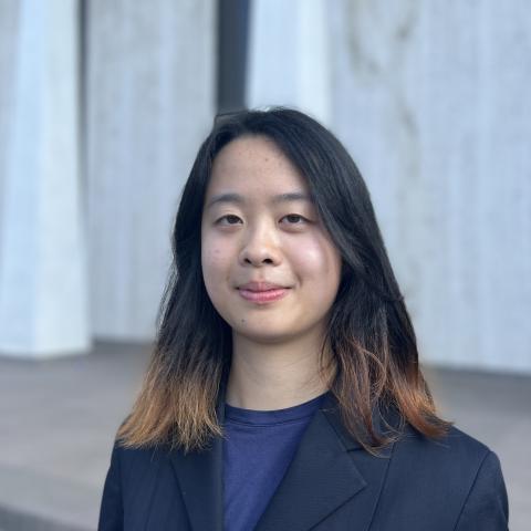 Connie Xu smiling in front of building