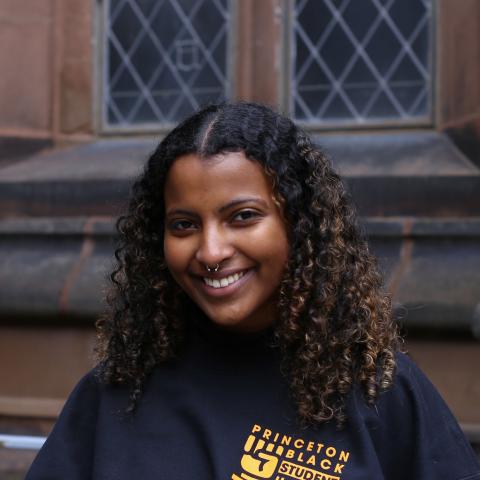 Student smiling in front of Princeton University building