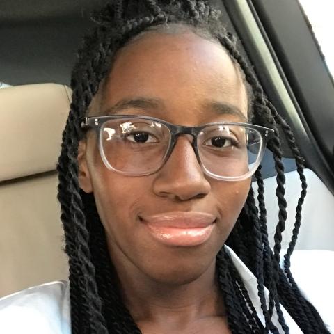 Student smiling in a car