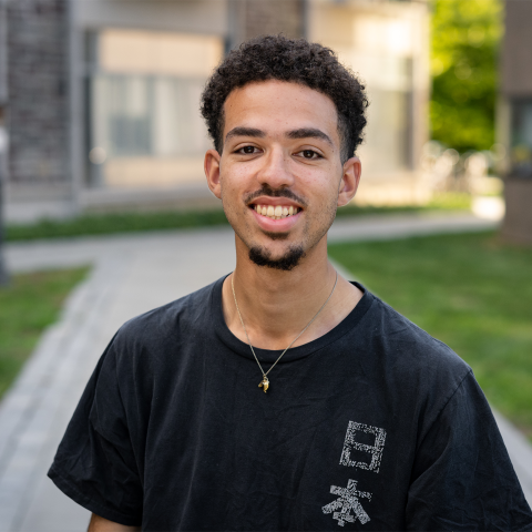 Student smiling outside