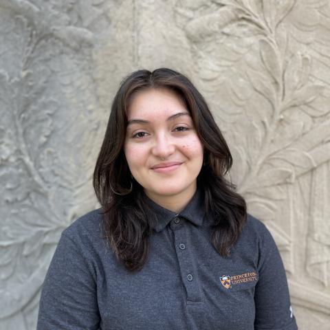 Student smiling in front of monument