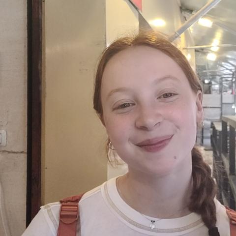 Smiling student standing in a breezeway