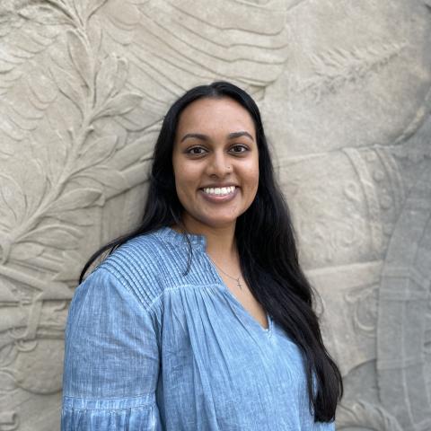 Student smiling in front of monument