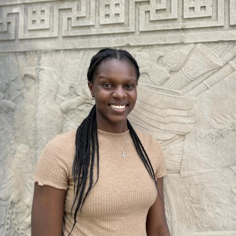 Student smiling in front of monument