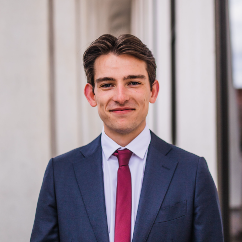 Professionally-dressed student smiling outside